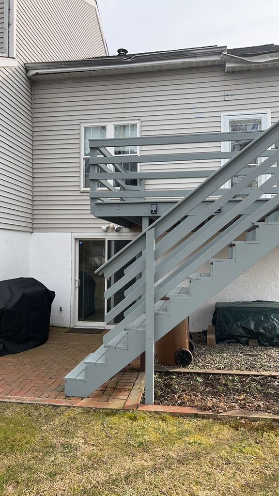 Old wooden rear deck and stairs on a townhome in Ambler, PA before the rebuild