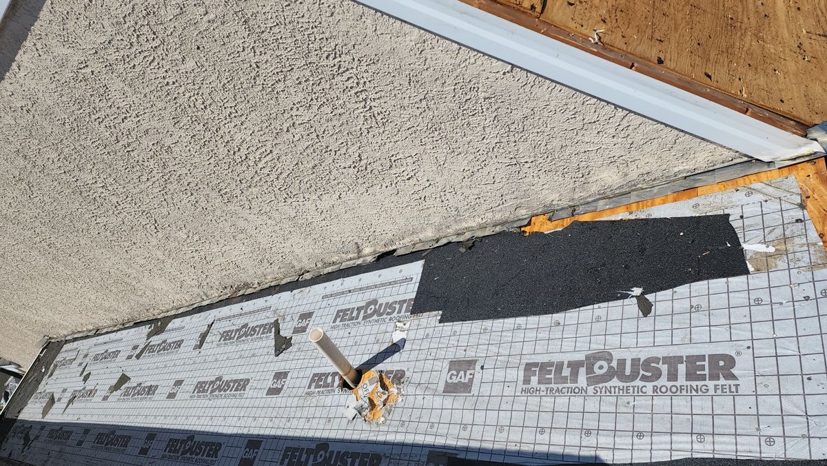 GAF FeltBuster underlayment going down where a roof meets a stucco wall in Ambler, PA