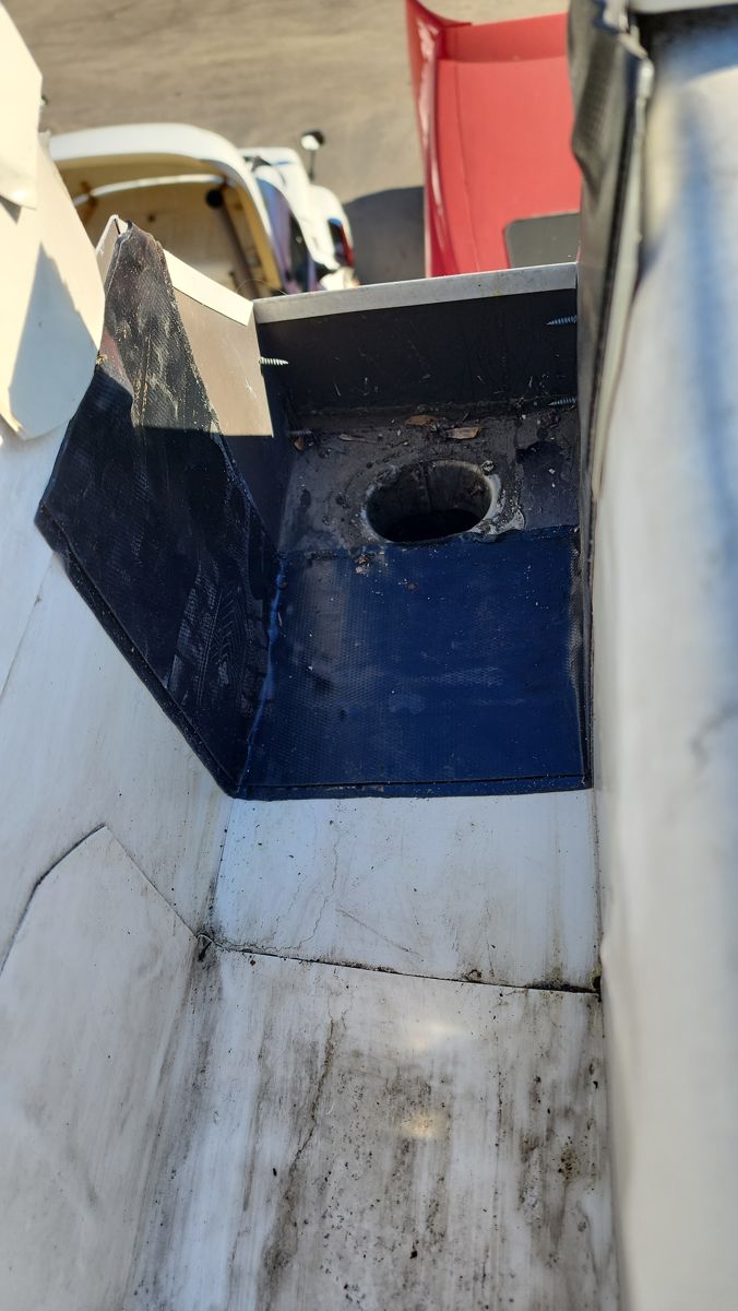 Drain outlet on a commercial flat roof lined with new dark membrane