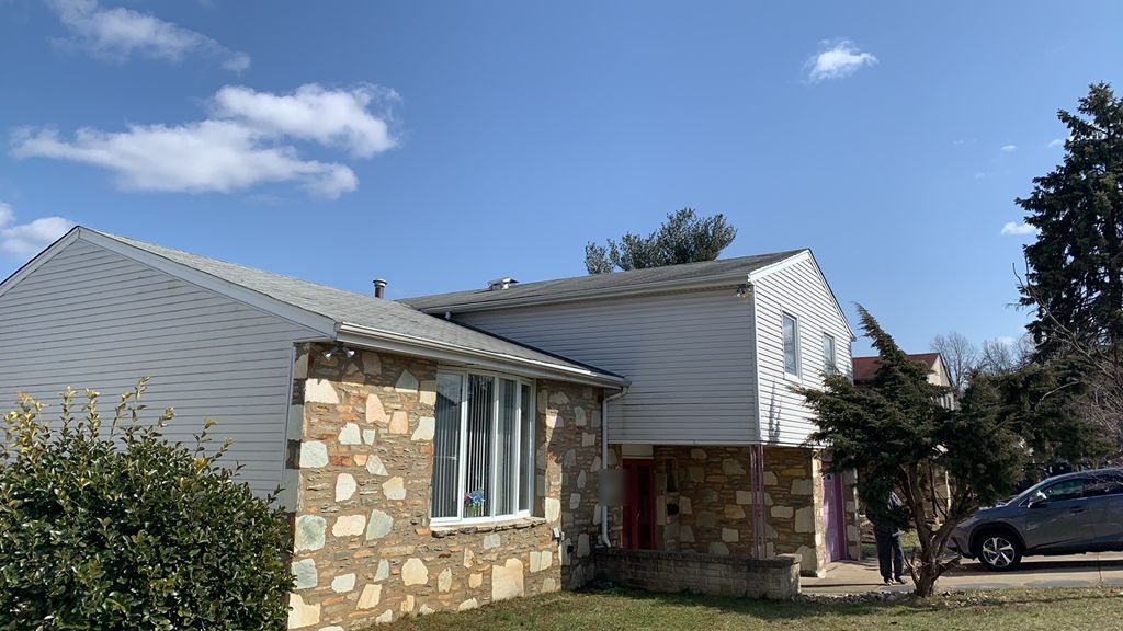 Stone-front split-level home with its old roof in Somerton, Philadelphia
