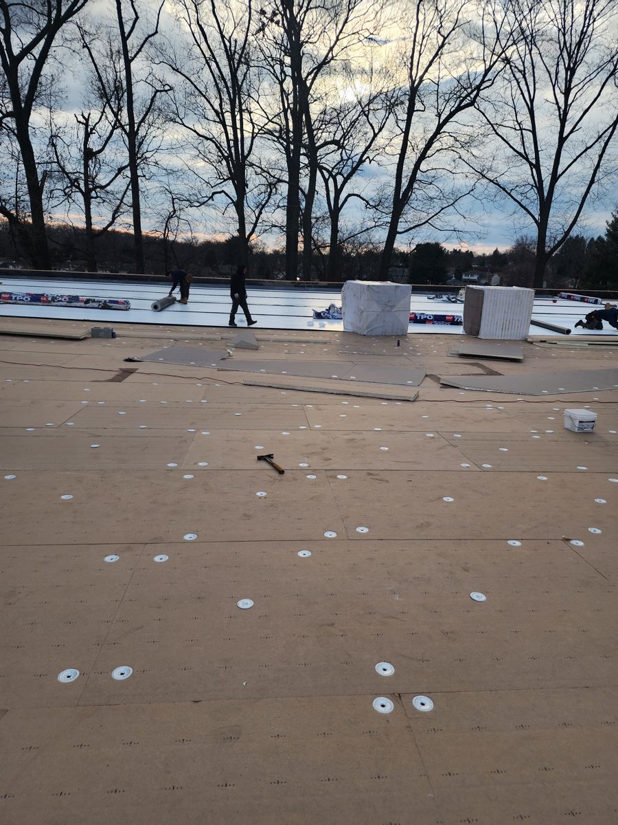 New insulation boards fastened down across a large commercial roof in Northeast Philadelphia