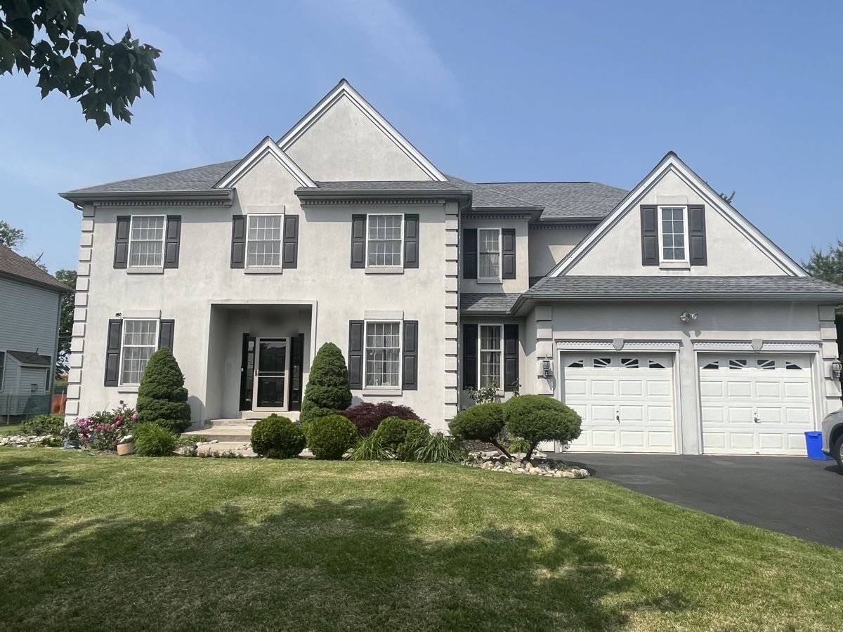 Large two-story home with a new gray GAF shingle roof in Northeast Philadelphia