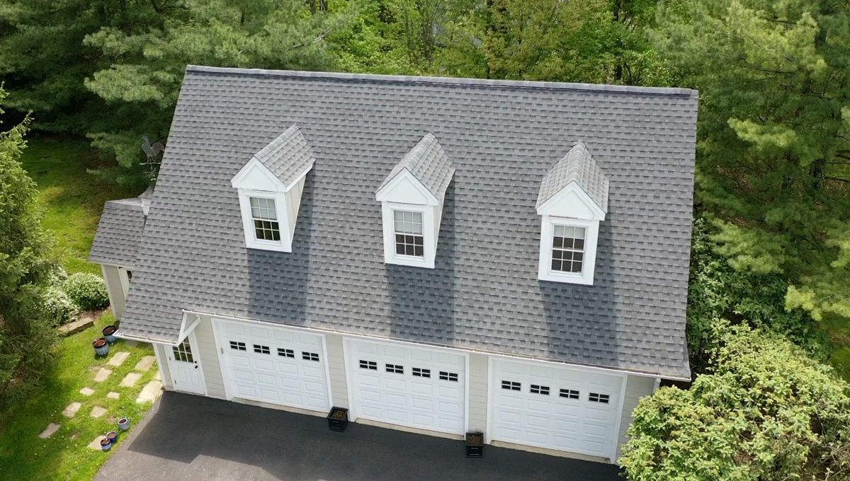 New gray shingle roof with three dormers on a three-car garage in Doylestown
