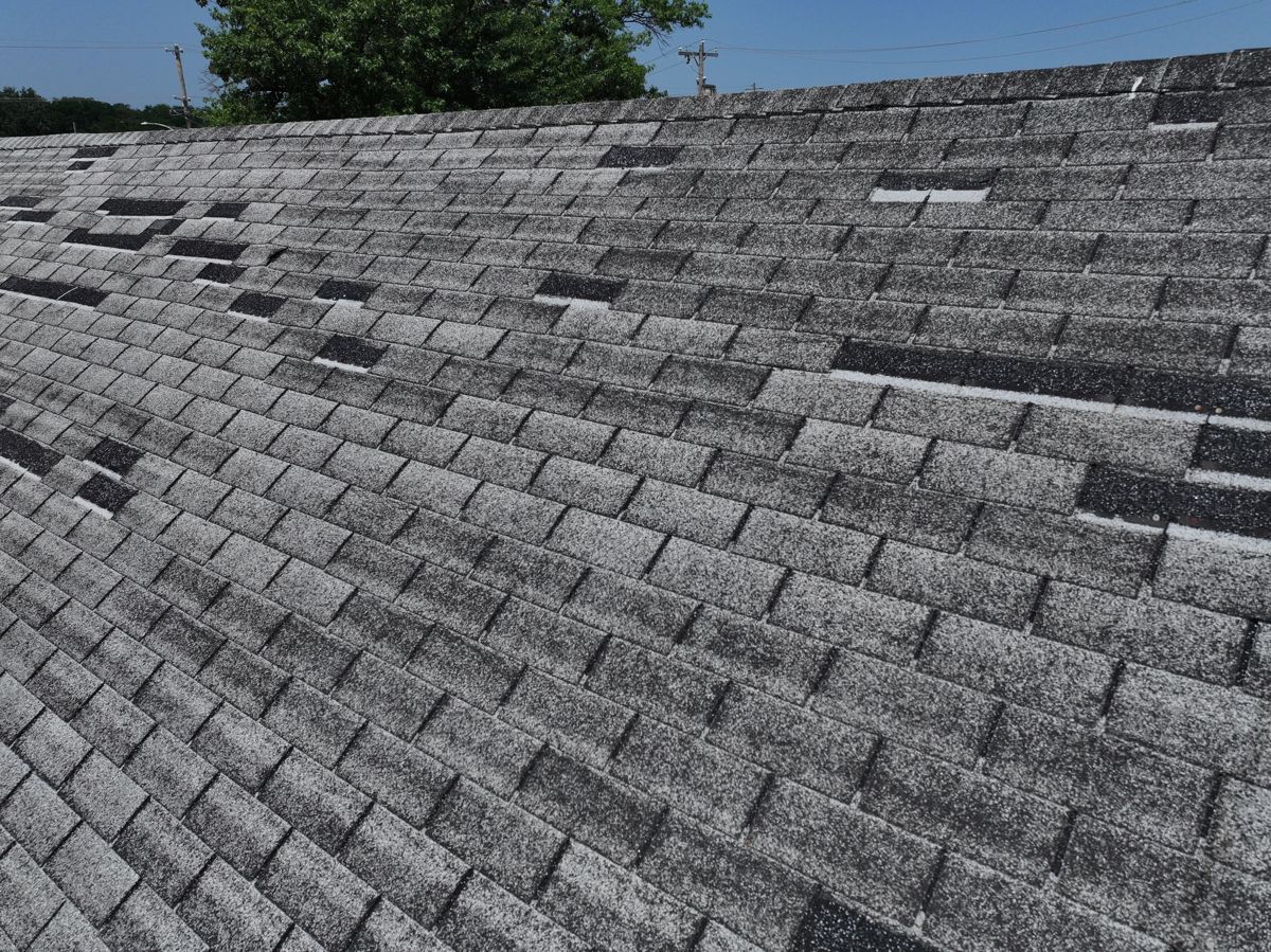 Old shingle roof with missing and patched tabs in Horsham, PA