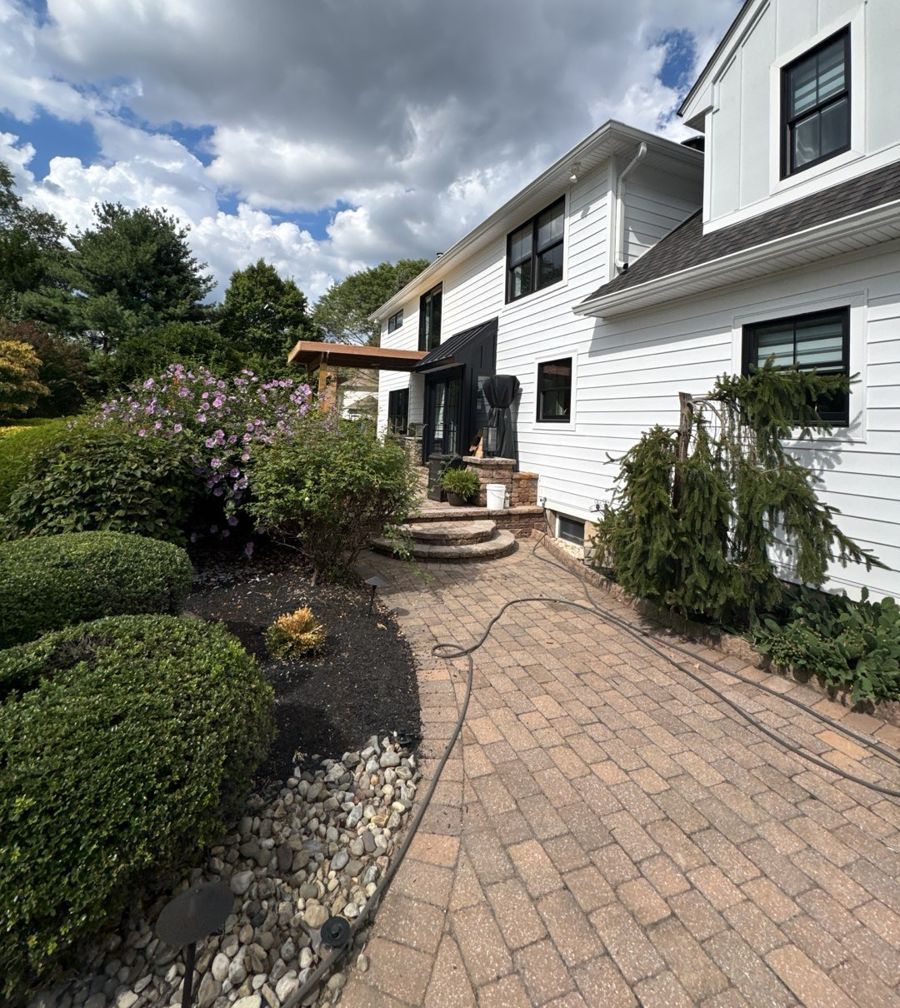 Finished white lap siding and black-framed windows on a Langhorne home
