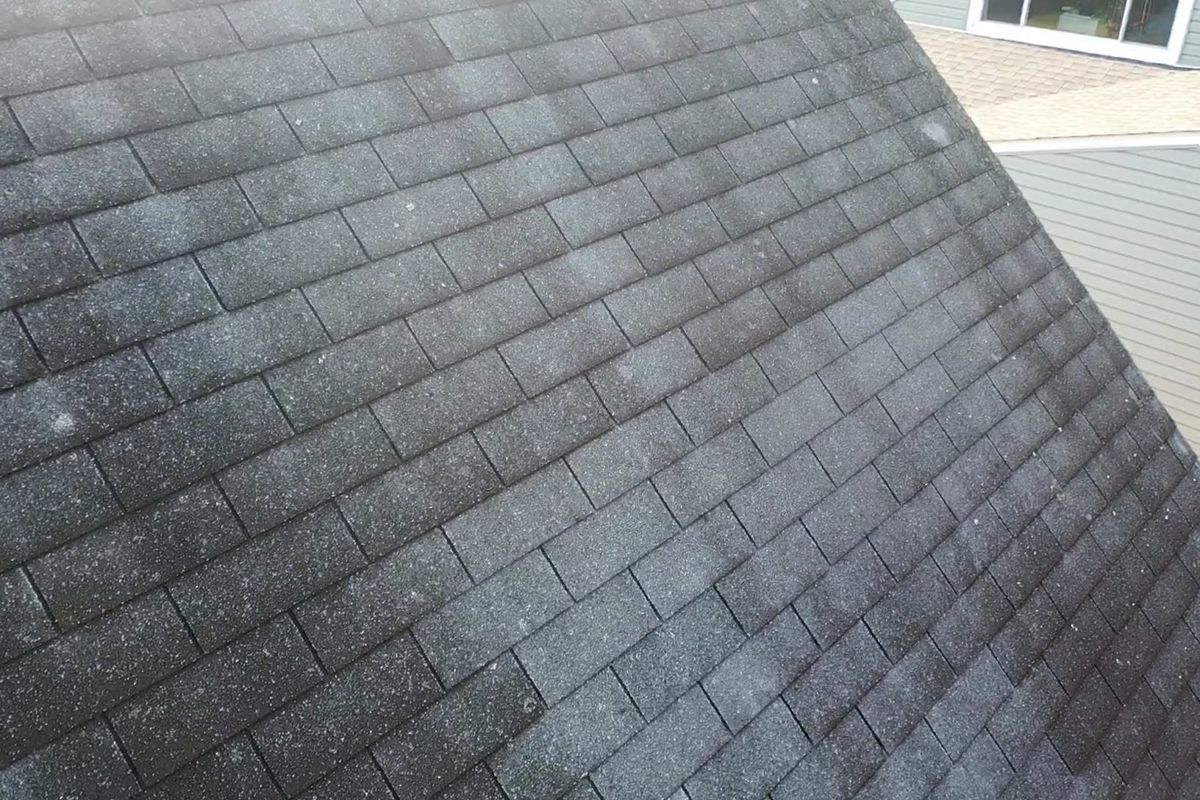 Worn, stained three-tab shingles on a Levittown, PA home before replacement