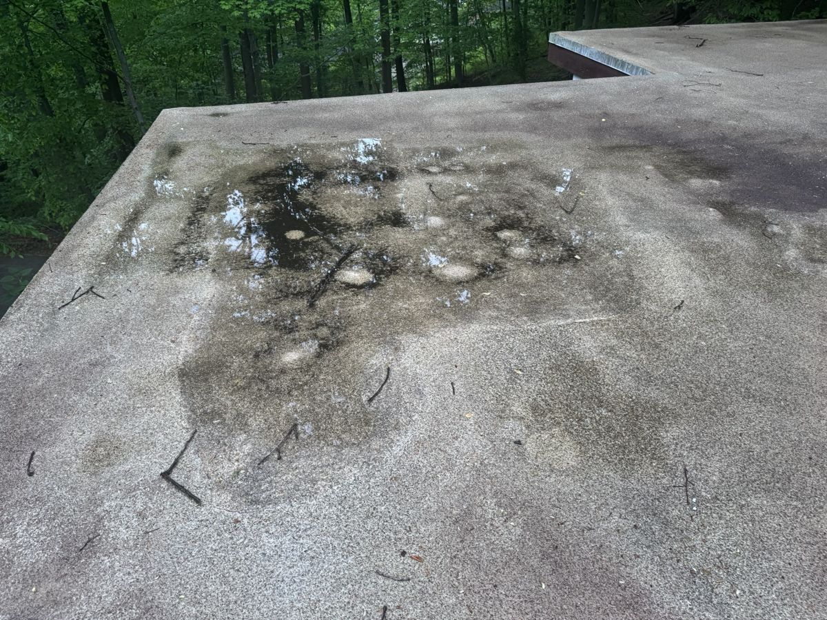 Worn flat roof in Penn Valley, PA with stains where water had been sitting