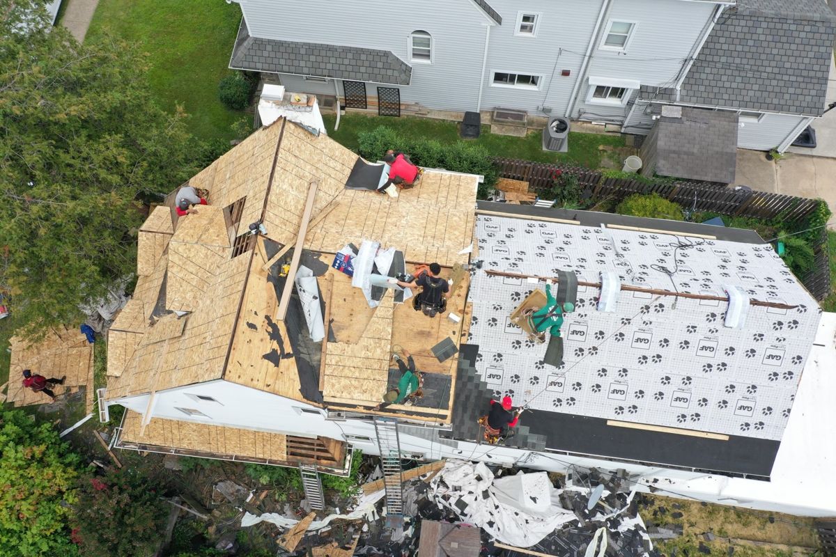Drone view of a roof in Penn Wynne, PA torn off to new plywood decking with GAF underlayment going down