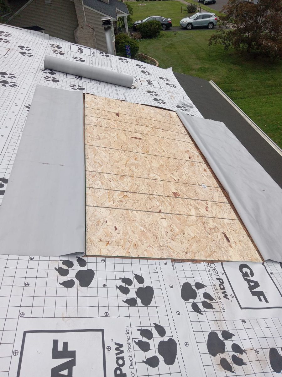 New OSB decking section and GAF underlayment during a roof replacement in Morrisville