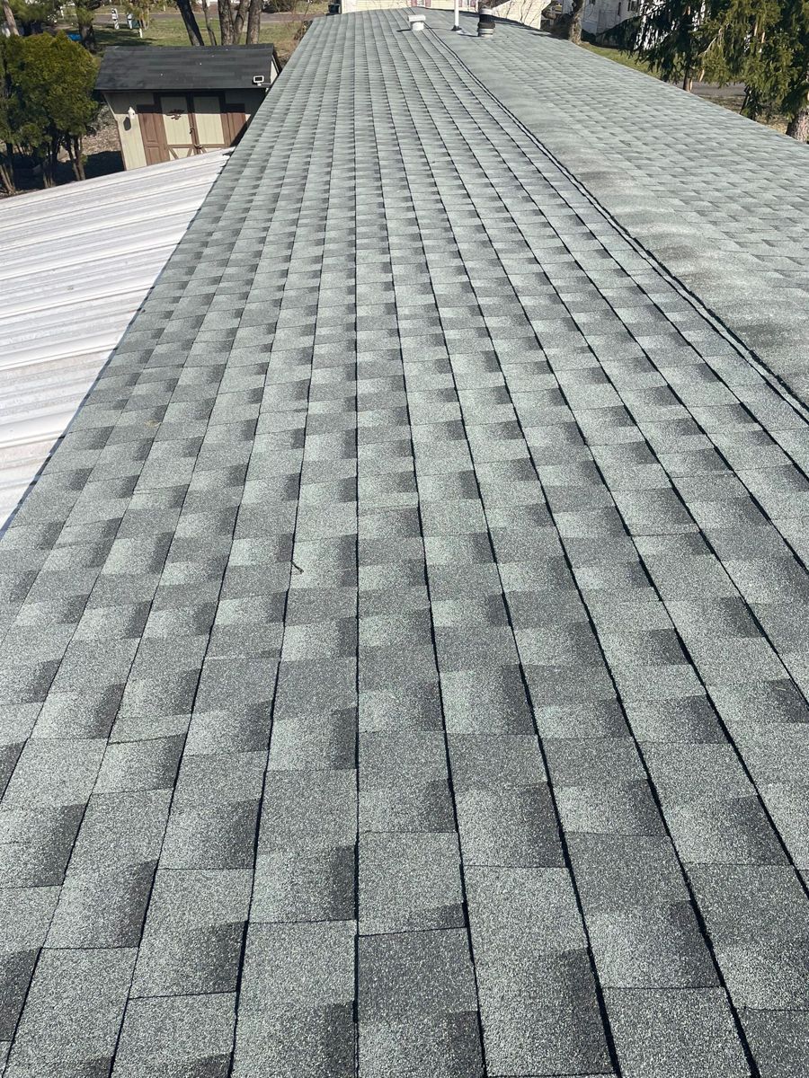 New gray shingle roof on a manufactured home in Morrisville, same angle as the before photo
