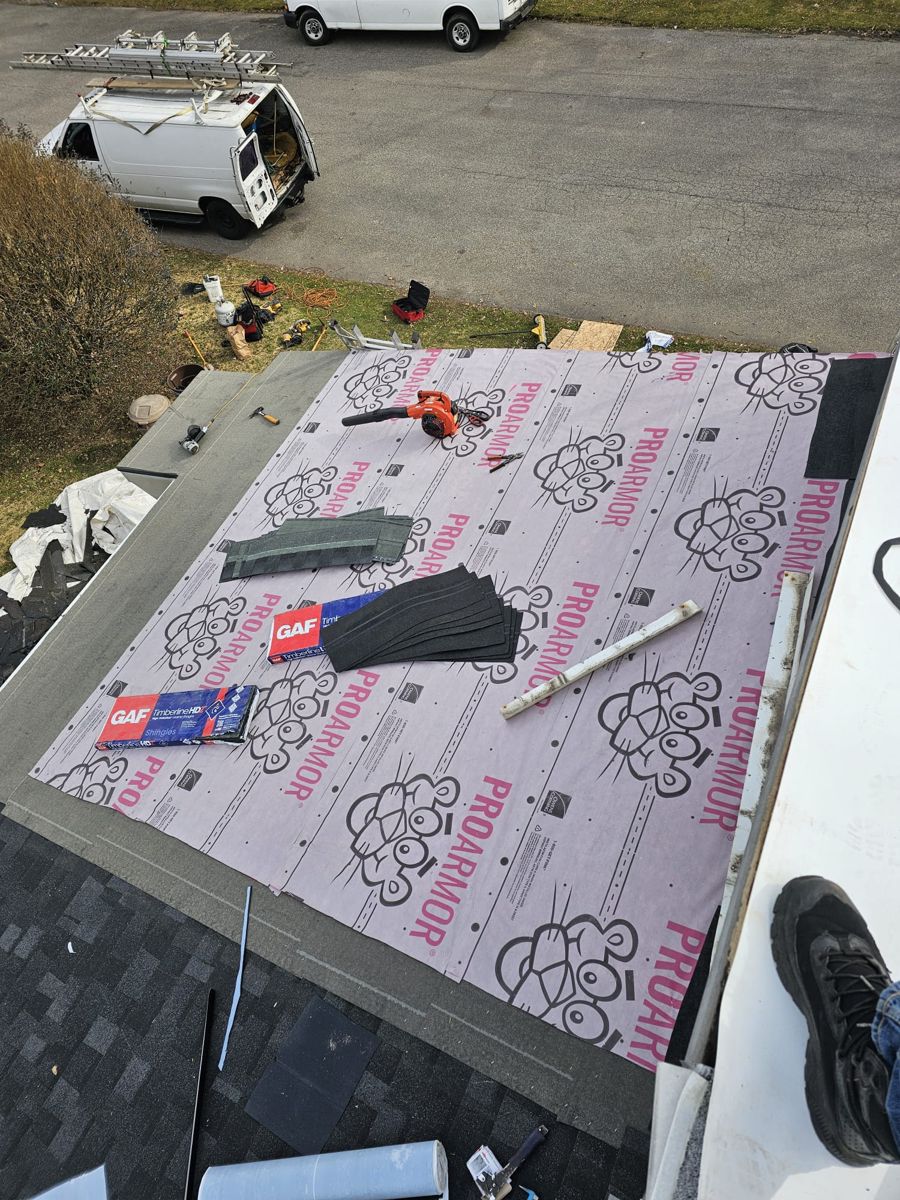 Synthetic underlayment and bundles of GAF Timberline HDZ shingles on a Morrisville roof