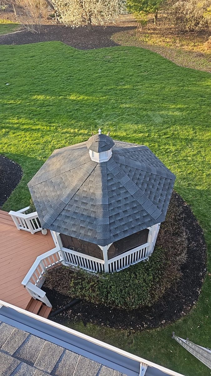 Backyard gazebo with a new shingle roof and cupola