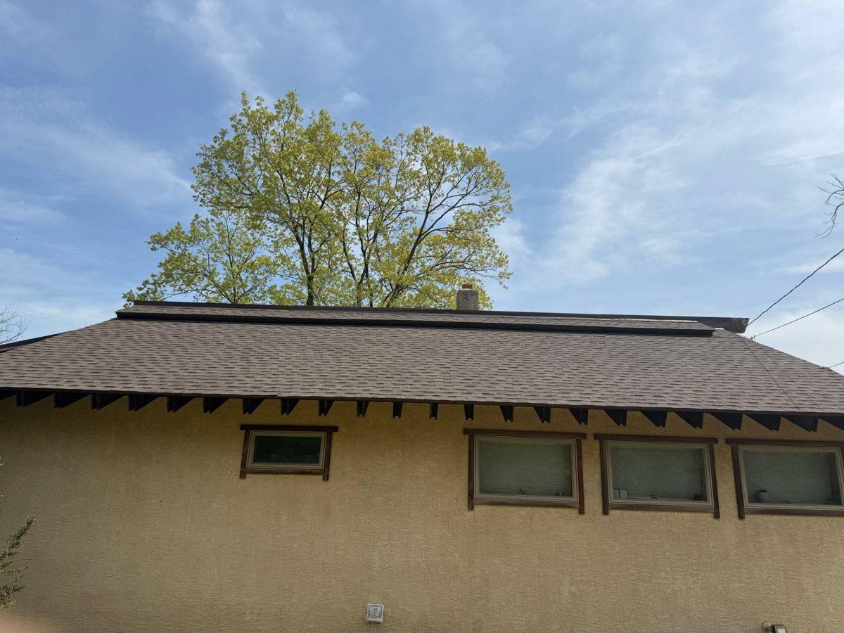 New asphalt shingle roof with the same stepped ridge on a stucco home in New Hope
