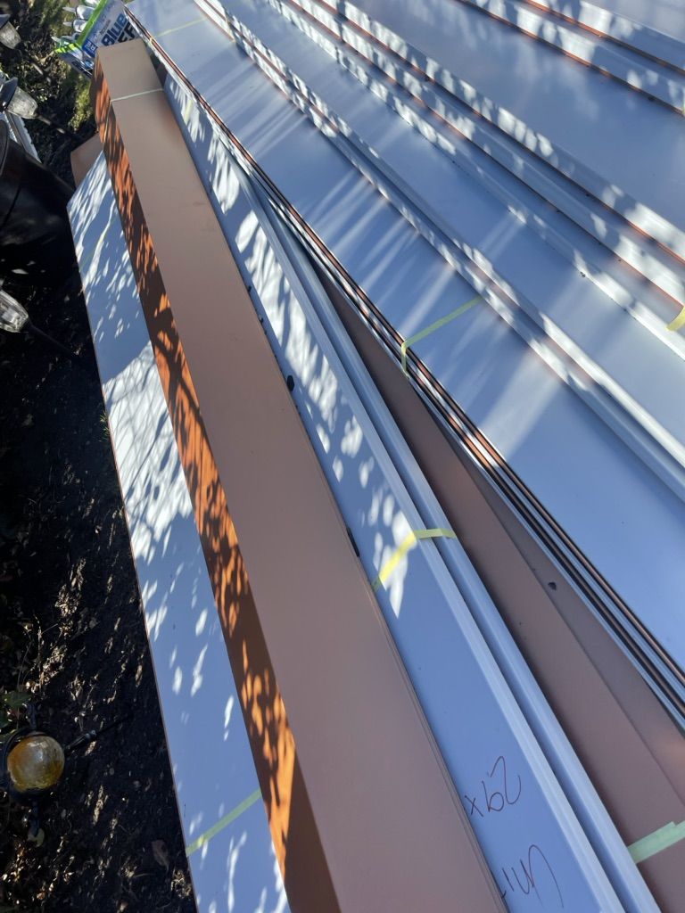 Standing-seam metal panels staged on a porch roof in North Wales, PA