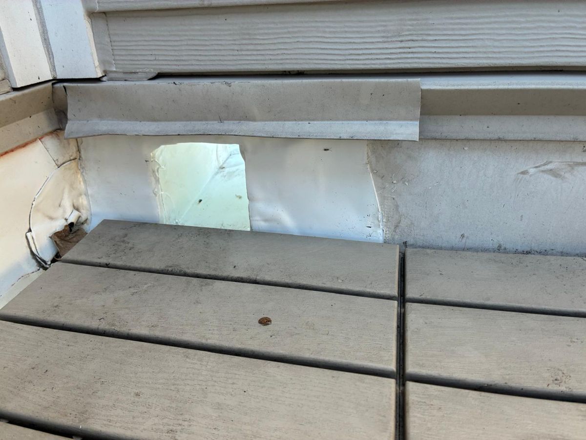 Old flat roof exposed after lifting roof deck tiles on a Philadelphia rowhome