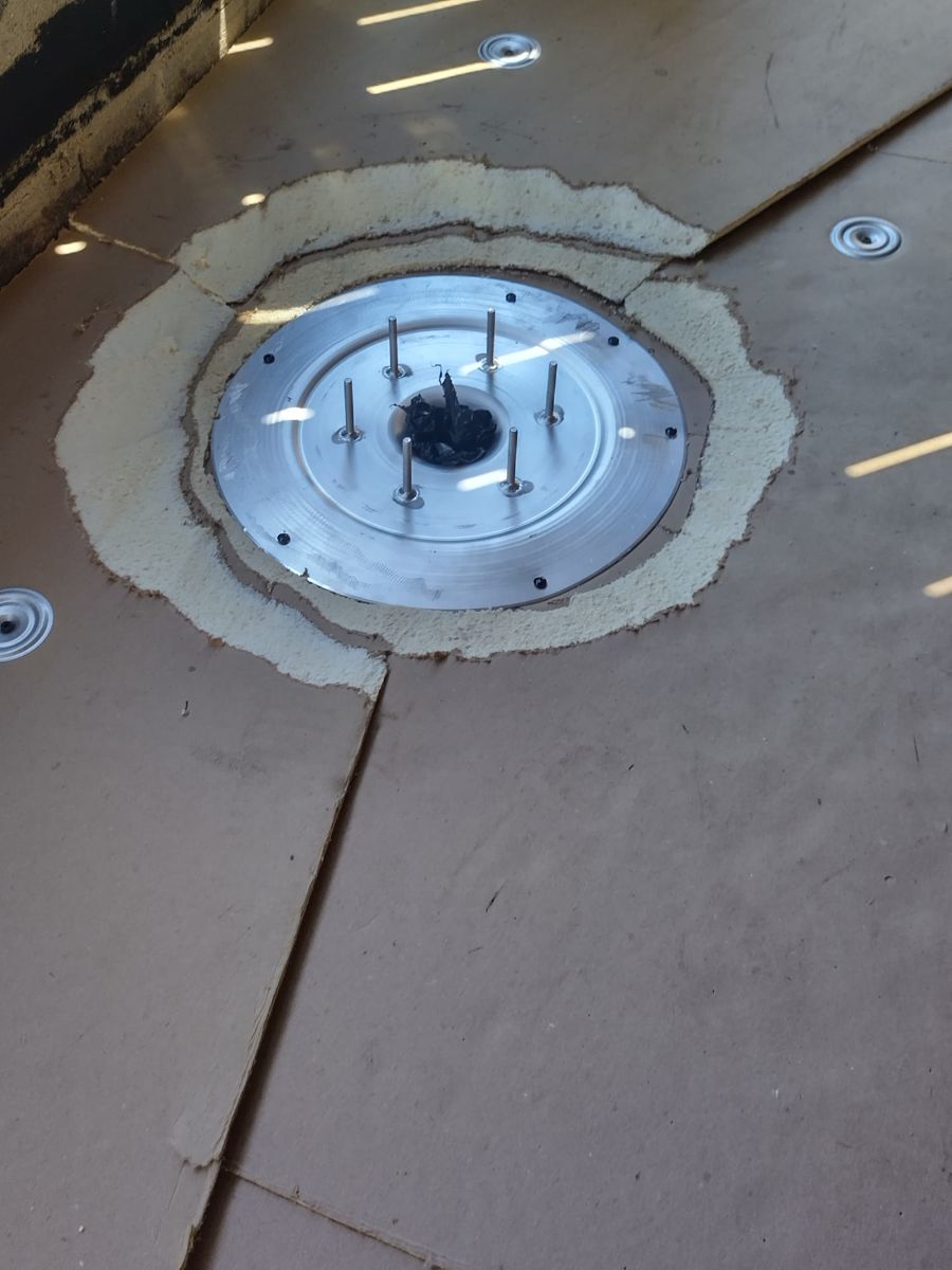 New roof drain set into tapered insulation boards on a Philadelphia rowhome flat roof