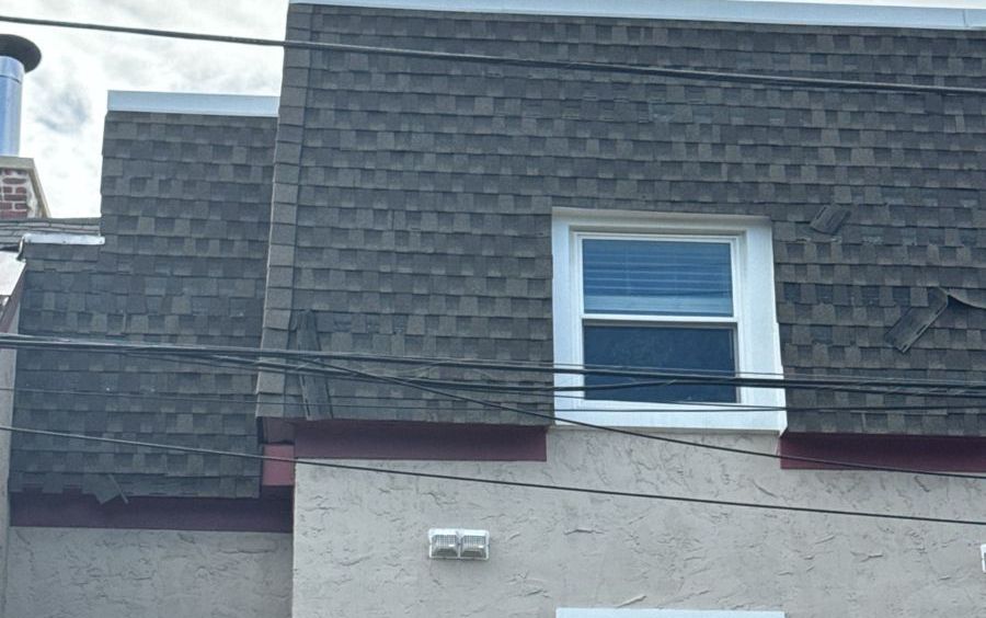 Old shingle mansard with loose and slipping shingles on a Philadelphia rowhome