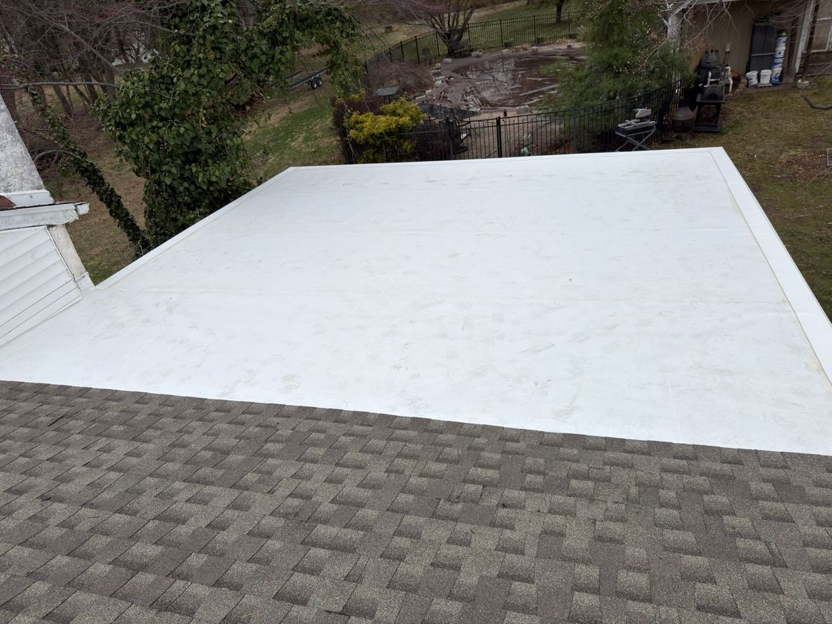 New white GAF EverGuard TPO flat roof meeting a shingle roof in Holland, PA