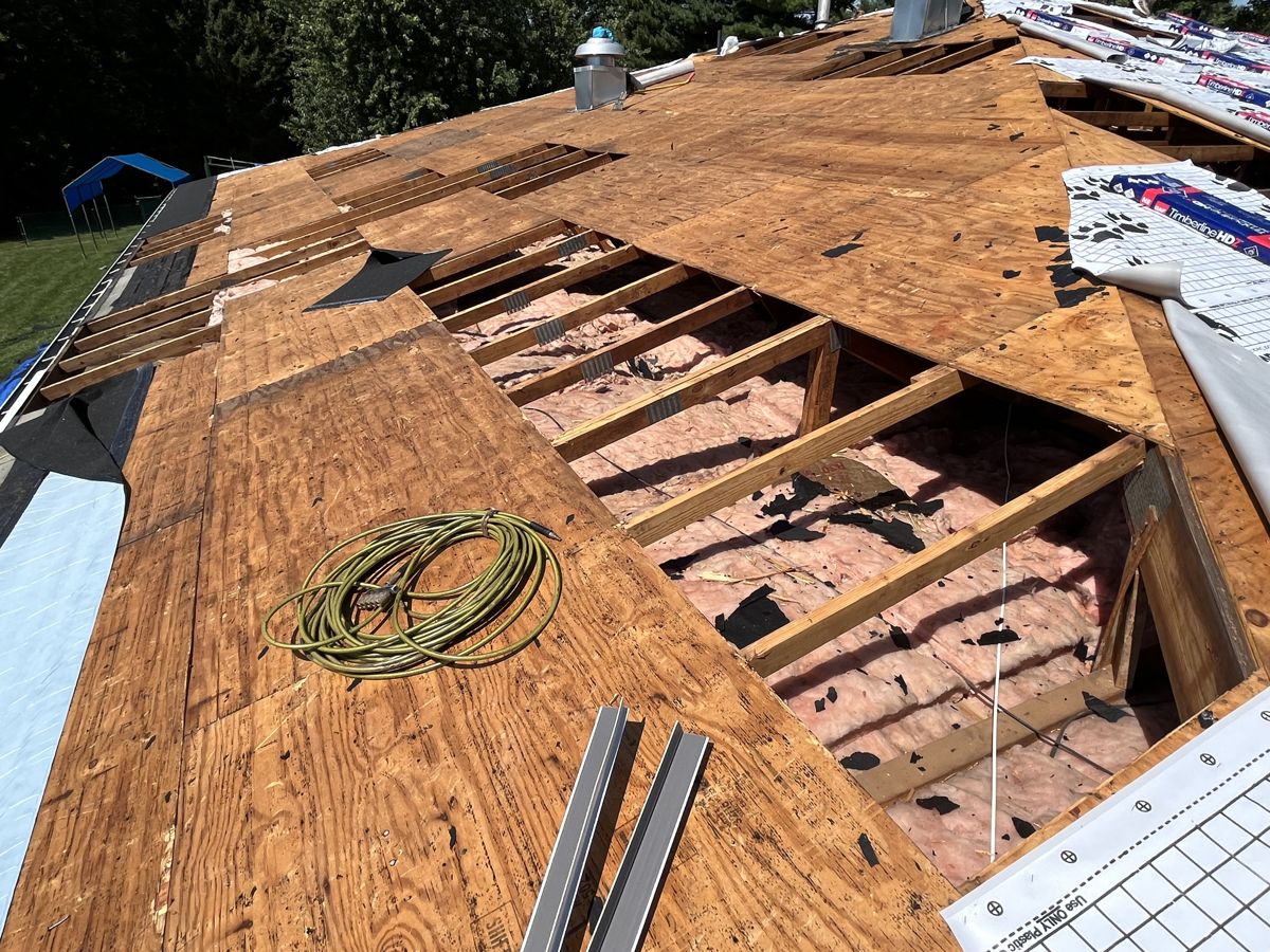 Damaged roof decking cut out to the rafters during a tear-off in Richboro, PA