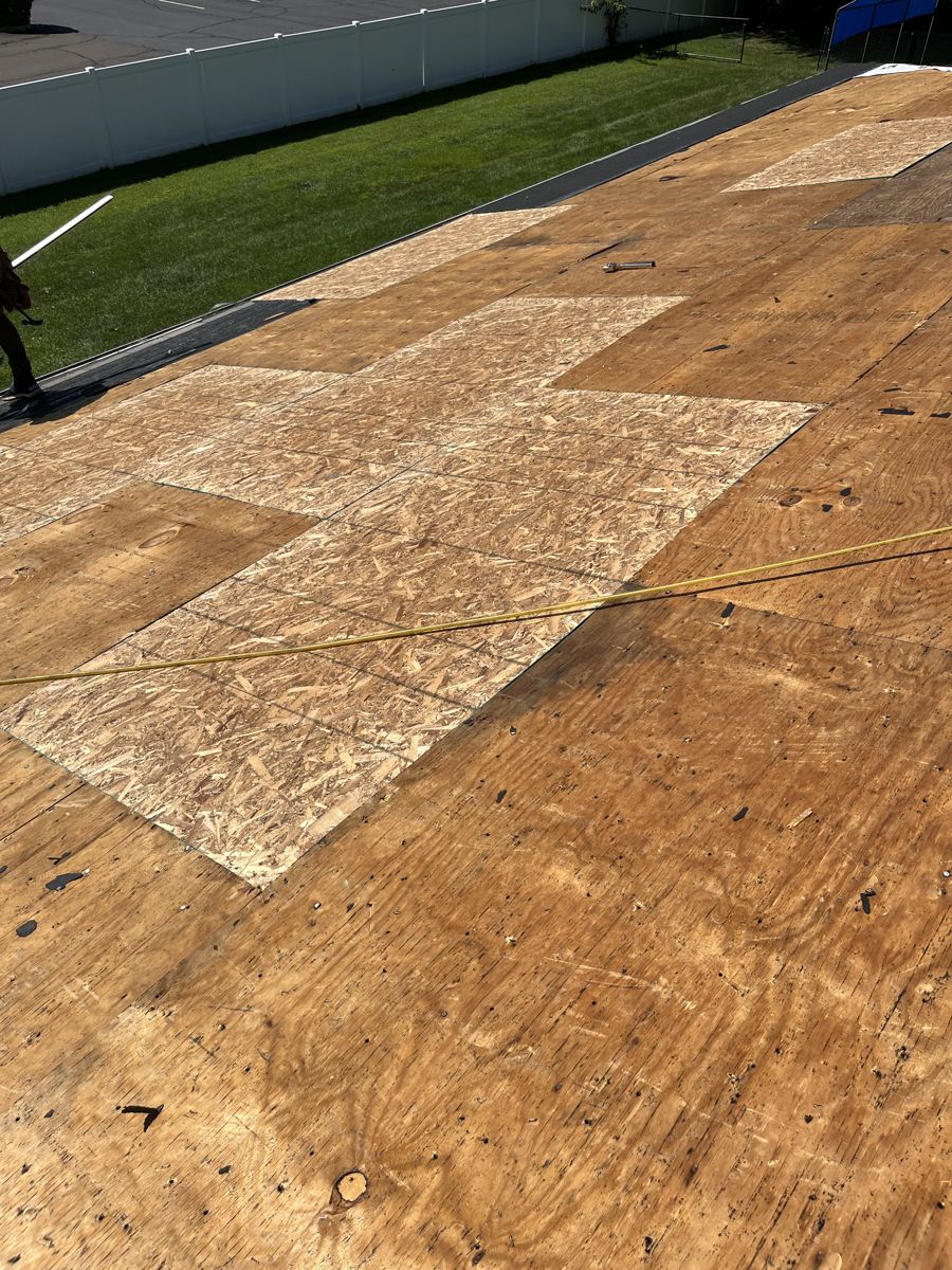New plywood sheets patched into an existing roof deck in Richboro, PA