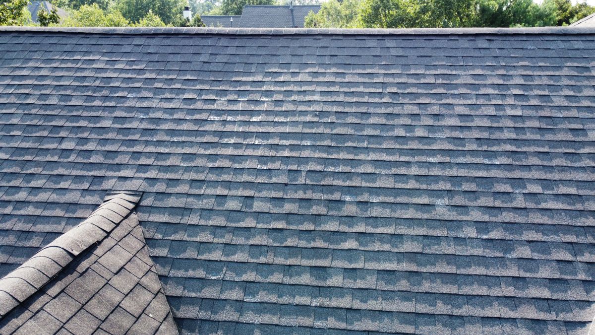 Worn, weathered asphalt shingles on a Southampton roof before replacement
