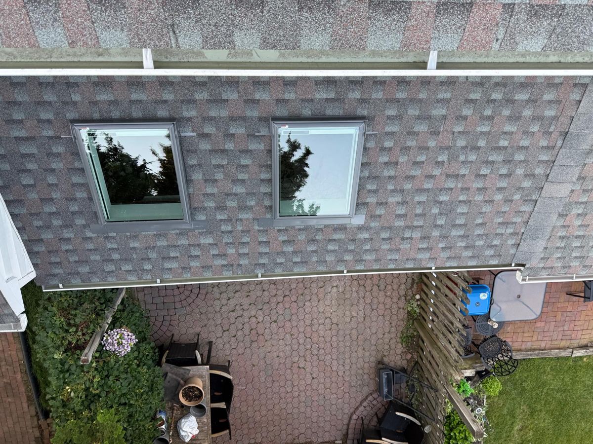 Finished GAF Timberline HDZ shingle roof with two skylights on a Southampton townhouse