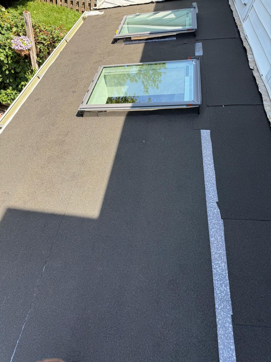 Underlayment laid around two skylights on the low-slope back section of a Southampton townhouse roof
