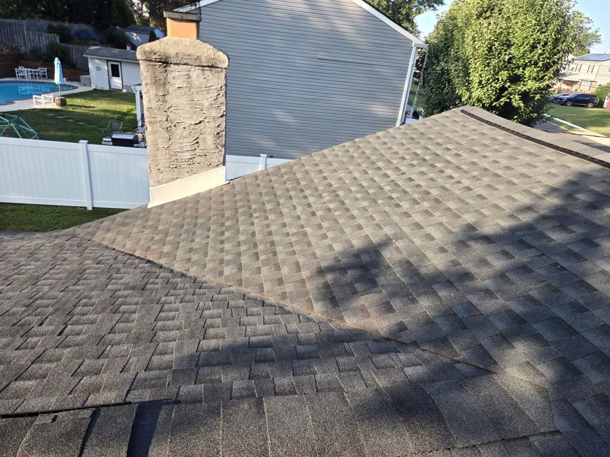 Finished GAF Timberline HDZ roof beside a chimney in Warminster