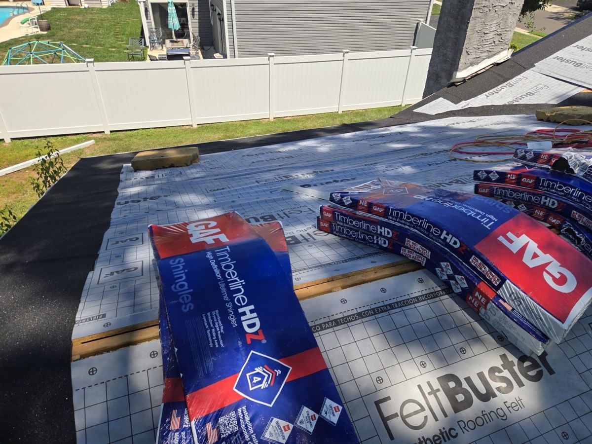 GAF FeltBuster synthetic underlayment and Timberline HDZ bundles on the roof deck