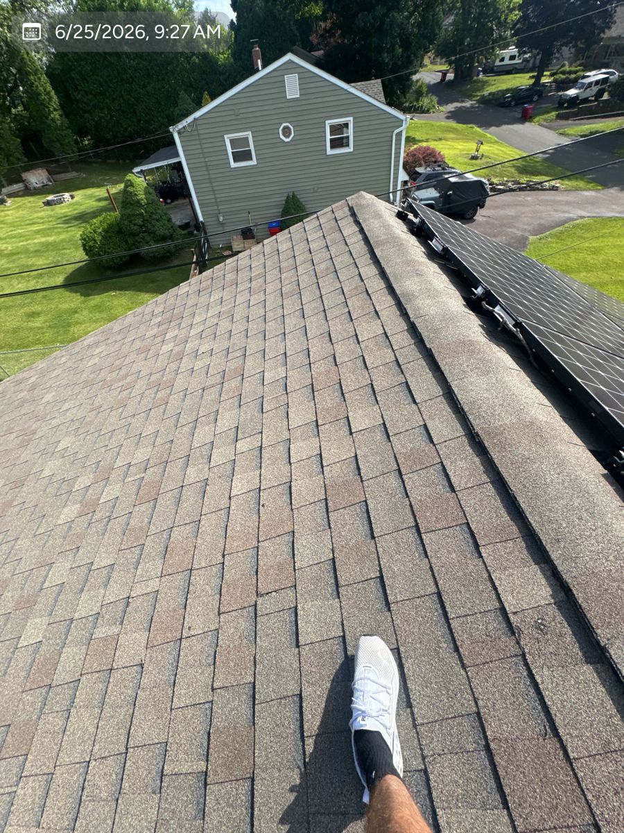 Worn brown asphalt shingles on a Warminster roof before replacement