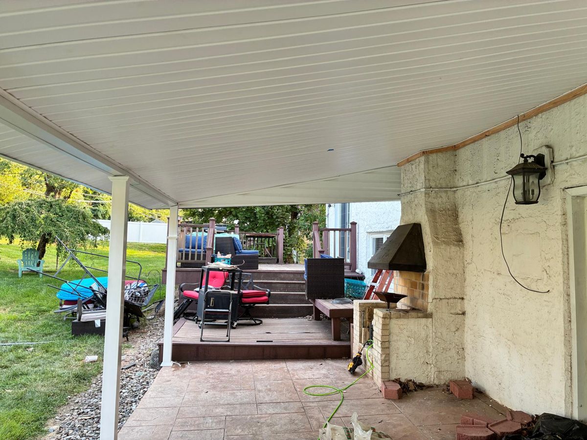 Finished white soffit ceiling under a rebuilt patio cover