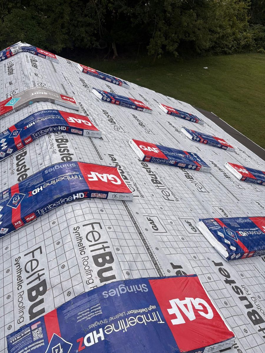 GAF FeltBuster synthetic underlayment and bundles of GAF Timberline HDZ shingles on a roof in Jamison, PA
