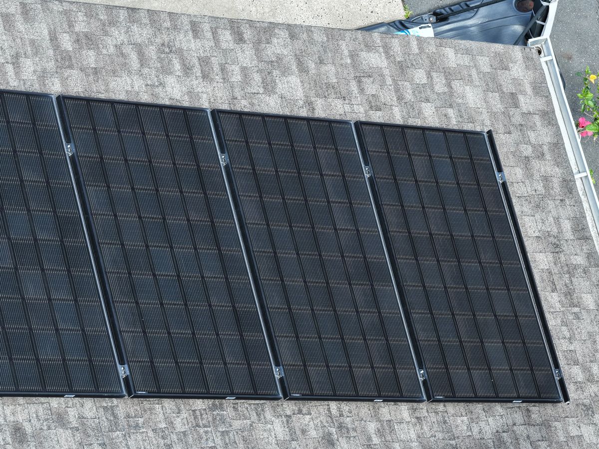 Four solar panels on an old shingle roof in Willow Grove, PA before replacement