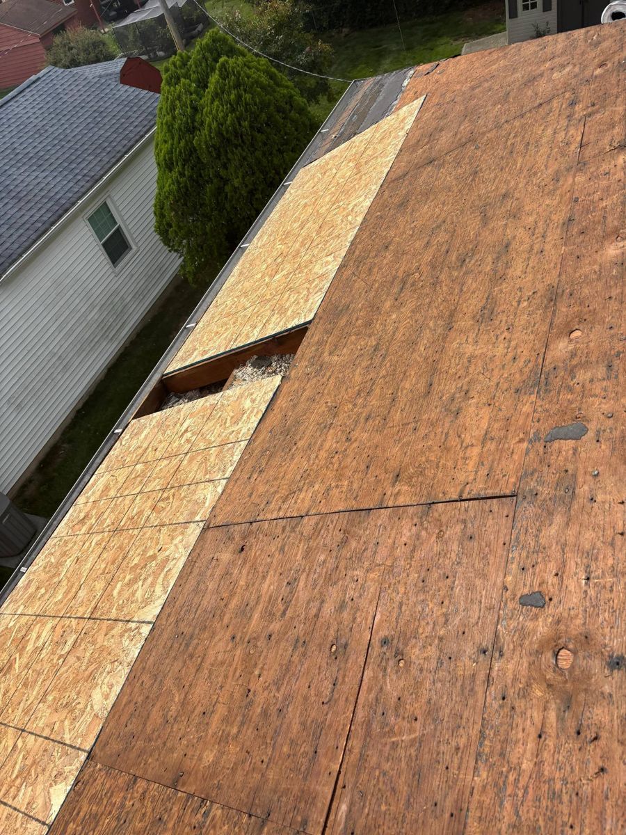 New plywood decking patched into an old roof deck during tear-off in Abington, PA