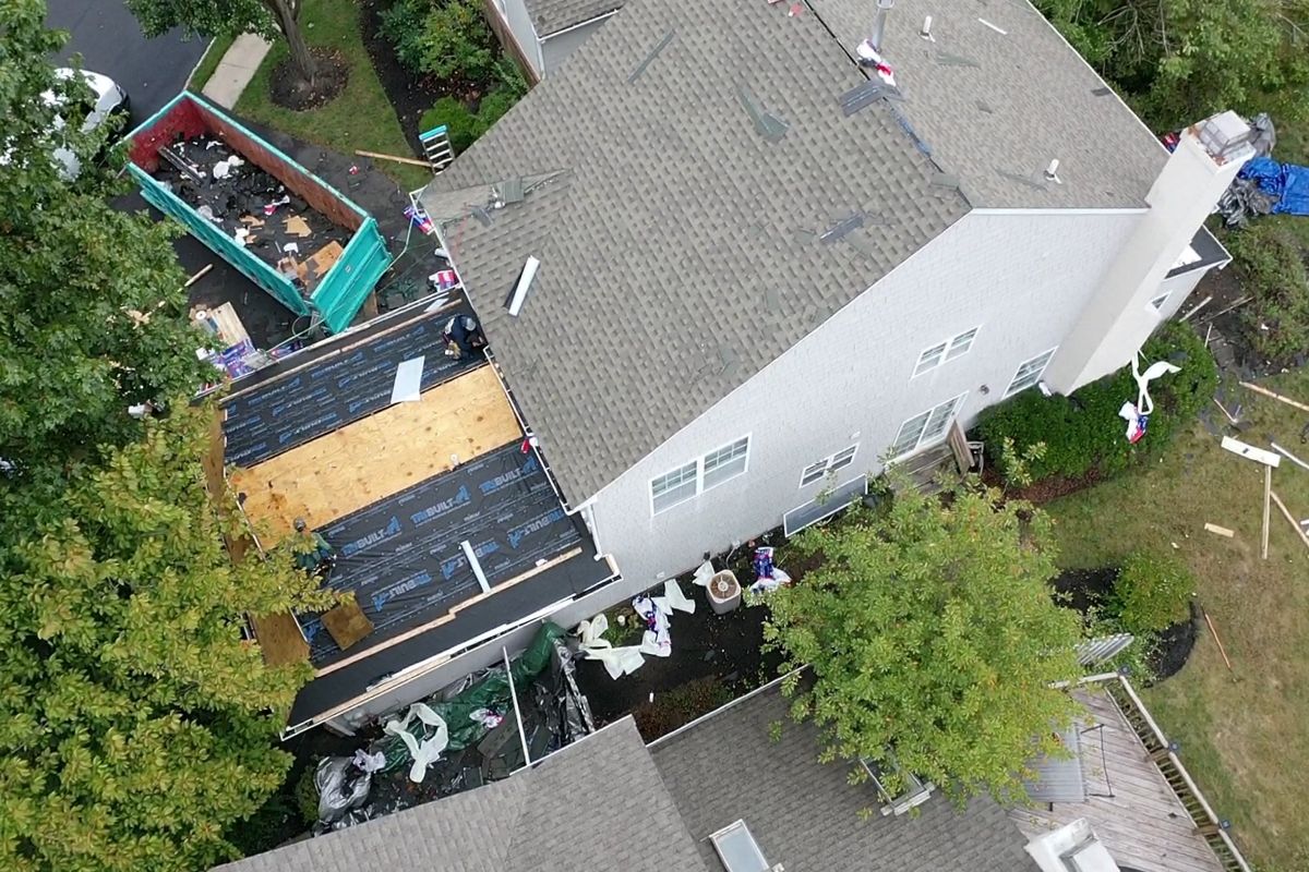 Aerial view of a Yardley roof replacement with the lower roof torn off to the decking