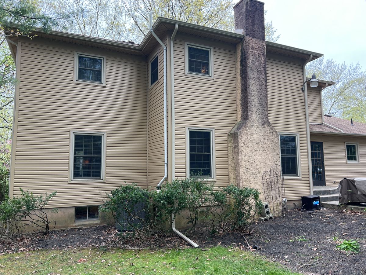 New tan siding on the back of a Yardley home after replacement