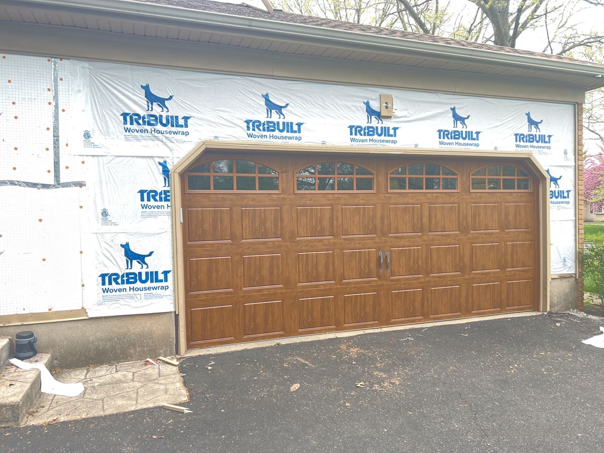 Woven house wrap on a garage wall with the old siding removed, Yardley