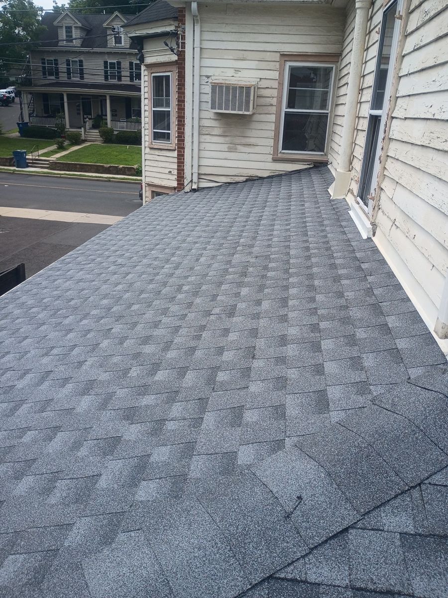 New gray GAF Timberline HDZ shingles on the rear roof of a building on South Main Street, Yardley